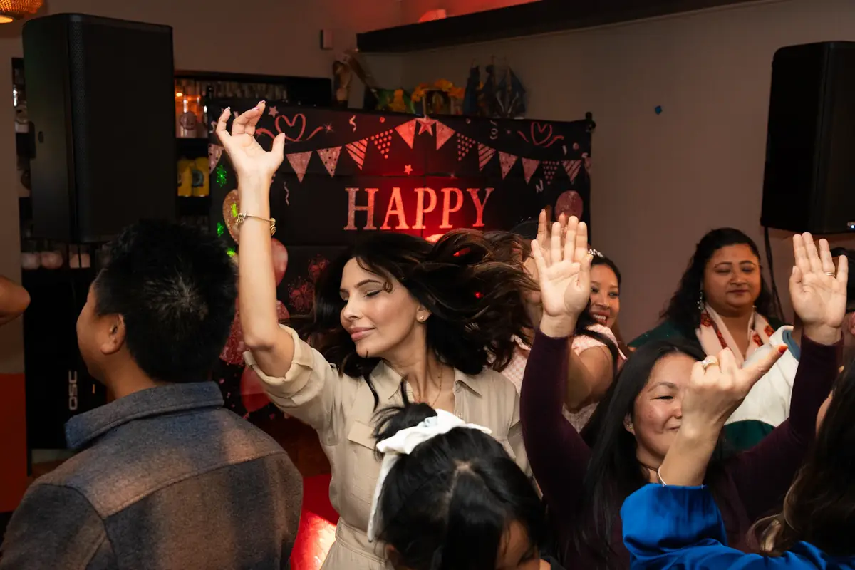 Birthday guests with their hands in the air