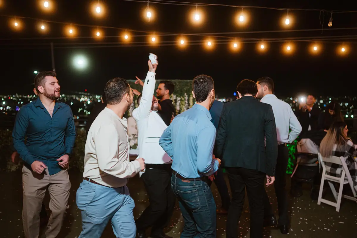 Guests dancing under festoon lights